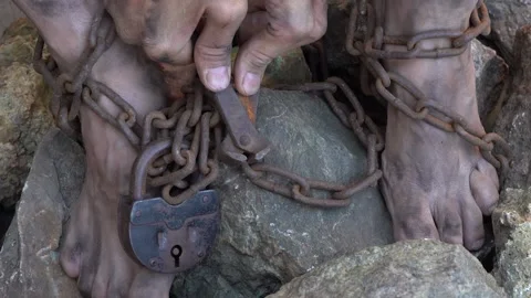 Slave Legs in Chains. Hands and Feet of a Slave Entangled in Iron Chains Video stock 150934644