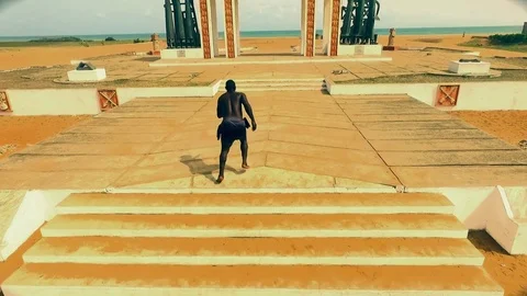 Slave running to the sea through Ouidah's door of no return Stock Footage 81664430