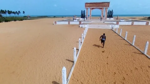 Slave running through Ouidah's door of No return Stock Footage 81219289