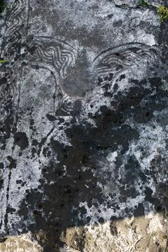 Slavic pattern on an ancient black gravestone close-up Stock Illustration