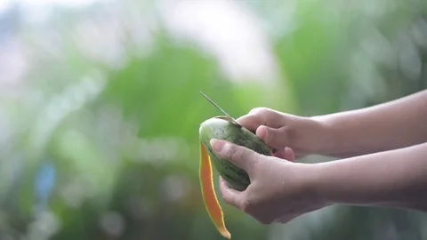 Сleaning of mango peel under rain Stock Footage 72108334