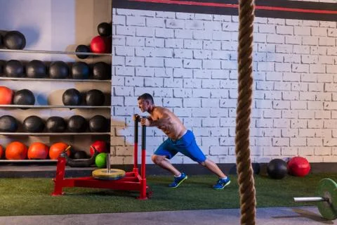 Sled push man pushing weights workout Stock Photos