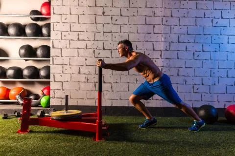 Sled push man pushing weights workout Stock Photos