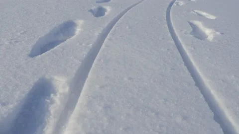 Sled tracks and footprints of two person on the snow Stock-Footage 149809017