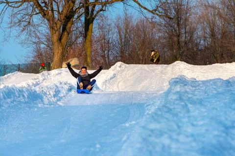 Sledding down a hill Stock Photos