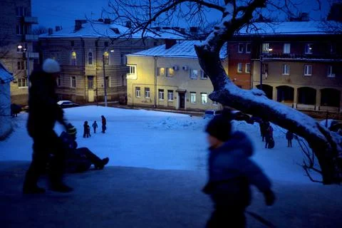 Sledding off a snow slide. Stock Photos