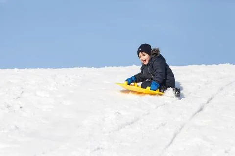 Sledding at winter time Stock Photos