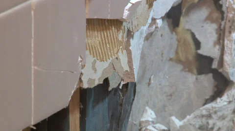 Sledge hammer pounds and breaks wall tile and sheetrock. Stock-Footage 39910928