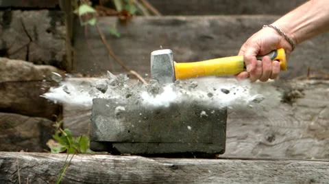Sledge hammer smashing a concrete block Stock Footage