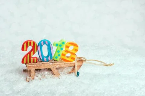Sledge on snow with figures 2018. Stock Photos