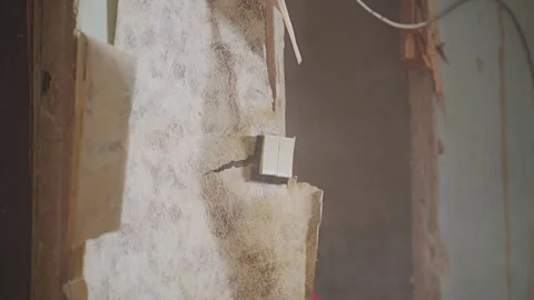 Sledgehammer Breaks Interior Partition Wall Revealing Dust and Light Switch Stock Footage 337930127