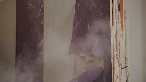 Sledgehammer Breaks Interior Wall, Flying Debris in Slow Motion Stock Footage 340867308