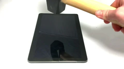 Sledgehammer is dropped horizontally onto a tablet Video stock 150266841