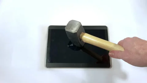 Sledgehammer falls horizontally onto a tablet Video stock 150267060