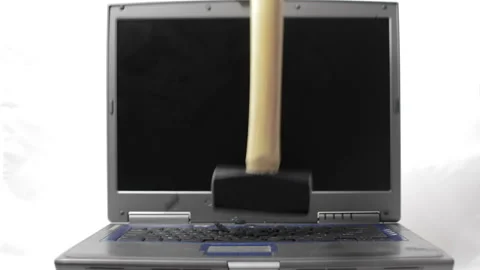 A sledgehammer falls on a laptop keyboard Video stock 150636454