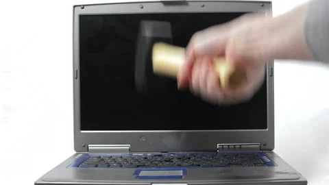 A sledgehammer hammers a laptop keyboard Video stock 150637389