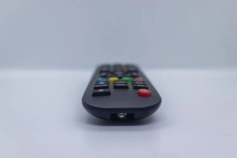Sleek and compact remote control with a variety of buttons. Stock Photos