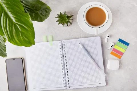 Sleek and Simple - Office Essentials Flat Lay with Pen and Notepad with a cup of Foto stock
