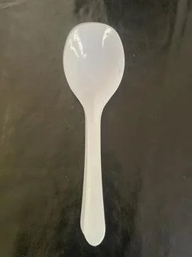A sleek and timeless white spoon for every dining occasion. Stock Photos