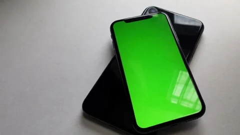 A sleek black iPhone Xs lies centered on a clean Stock Footage 333777314