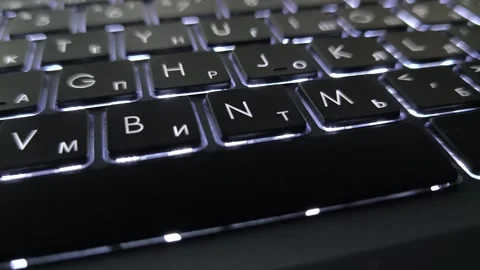 Sleek Black Keyboard with Backlit Keys Featuring Cyrillic &amp; Latin Characters Video stock 305684694