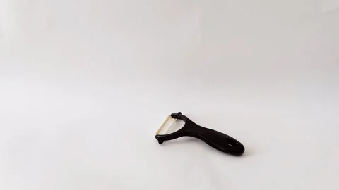 Sleek Ceramic Peeler on White Surface- Clean Kitchen Tool Closeup Video stock 318134718