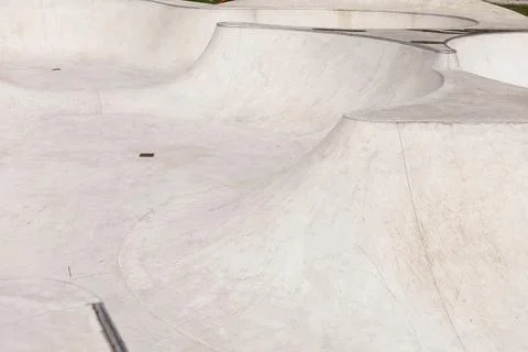 The sleek concrete structure features interconnected ramps and bowls tailored Stock Photos