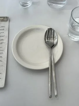 A sleek cutlery set featuring stainless steel forks, knives, and spoons wit.. Stock Photos