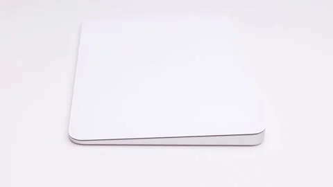 Sleek looking rotating white Apple magic trackpad with large touch area Stock Footage 172480379