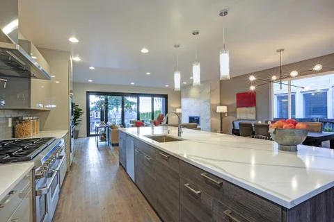 Sleek modern kitchen design with a kitchen peninsula fitted with a gray and w Stock Photos