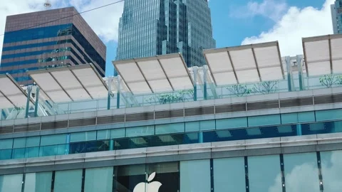 A sleek, modern multi-story building with white slatted horizontal structures Stock Footage 338165234