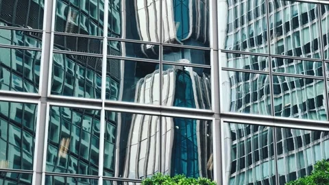 A sleek modern multi-story building with a geometric facade composed of white Stock Footage 338165288