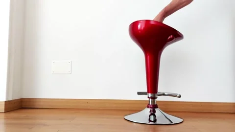 Sleek Red Bar Stool Adjusted on Wood Floor Spins By Hand 스톡 동영상 317293523