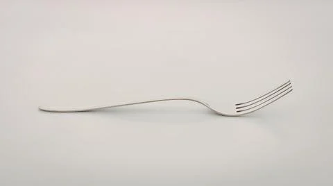 Sleek silver fork on clean surface Stock Photos