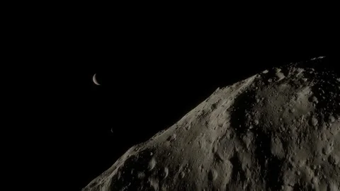A sleek tracking shot of the moon Nix as it drifts into frame, revealing the Stock Footage 334290407