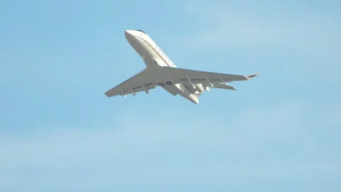 Sleek Unmarked Generic Executive Jet Flying Up into a Blue Sky Stock Footage 247136547