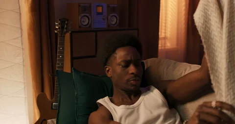 Sleep problems. Young man does not sleep, covers himself with a blanket, gets up Stock Footage 200798465