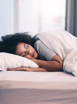 Sleeping, African woman and bed with morning nap in home with rest feeling calm Stock Photos
