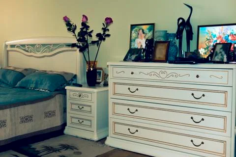 Sleeping area with bedside table and chest of drawers 스톡 사진