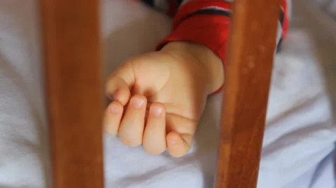 As for the sleeping baby's hand and stroked father's hand close-up Stock Footage 49447008