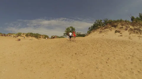 Sleeping Bear Dune Area (Part 10: Unidentifiable People on Dunes C, Camera Pans) Video stock 24975931