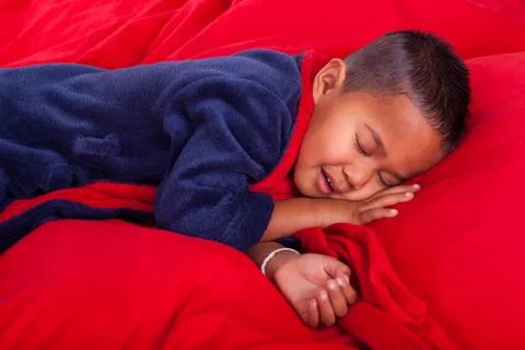 Sleeping boy in bed Stock Photos