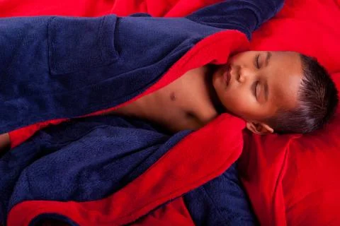 Sleeping boy in bed Stock Photos