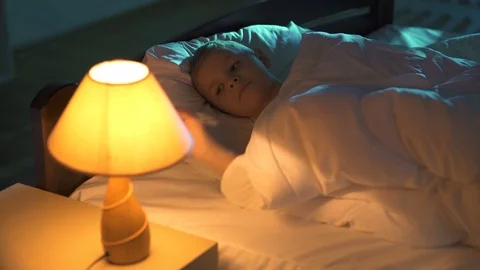 The sleeping boy turn off the lamp. Evening night time. Real time capture Stock Footage 71964405