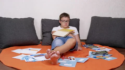 Sleeping Child Lying on Floor on a Cover in Pillows with a Book on Stomach Stock-Footage 201308757