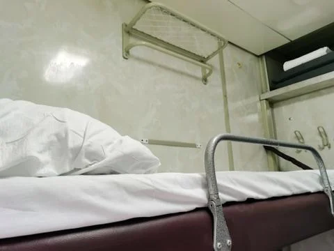 Sleeping compartment of a passenger train from the inside. Stock Photos