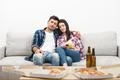 The sleeping couple with chips sitting on the sofa on the white background Photo