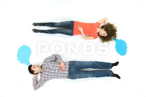 The sleeping couple lay near the dialog signs. View from above Stock Photos