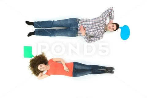 The sleeping couple lay near the dialog signs. View from Stock Photos