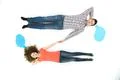 The sleeping couple lay near the dialog signs. View from above Photo
